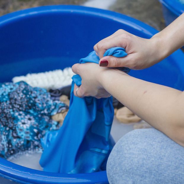 bigstock Washing Blue Clothes By Hand  342384769