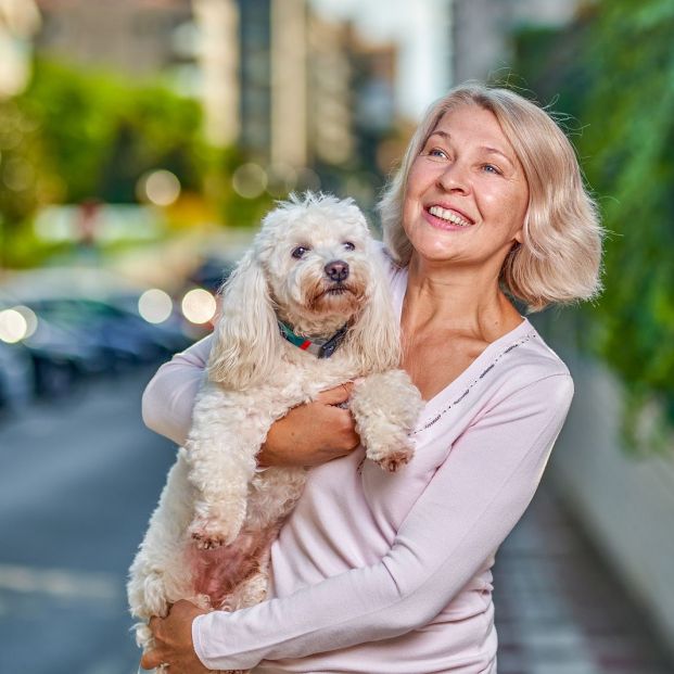 bigstock Happy Woman With A Dog In Her  384158096